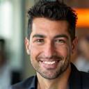 Michael Torres, VP Client Success, smiling in team meeting.