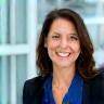 Lisa M., VP Technology at Avid Corp, smiling in office environment.